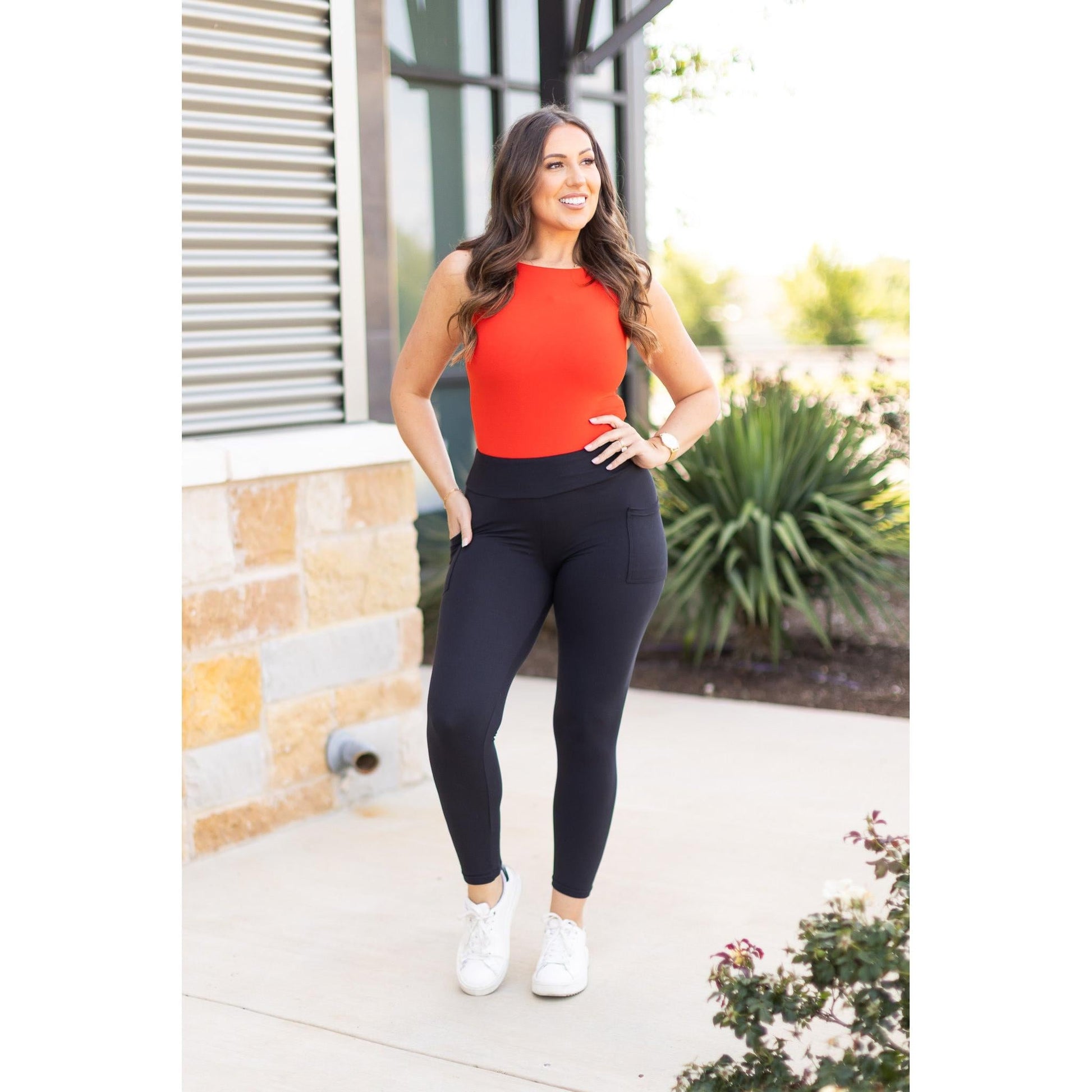 High-waisted black ankle length leggings with pockets by Julia Rose, Julia Rose women’s black 7/8 leggings lifestyle image