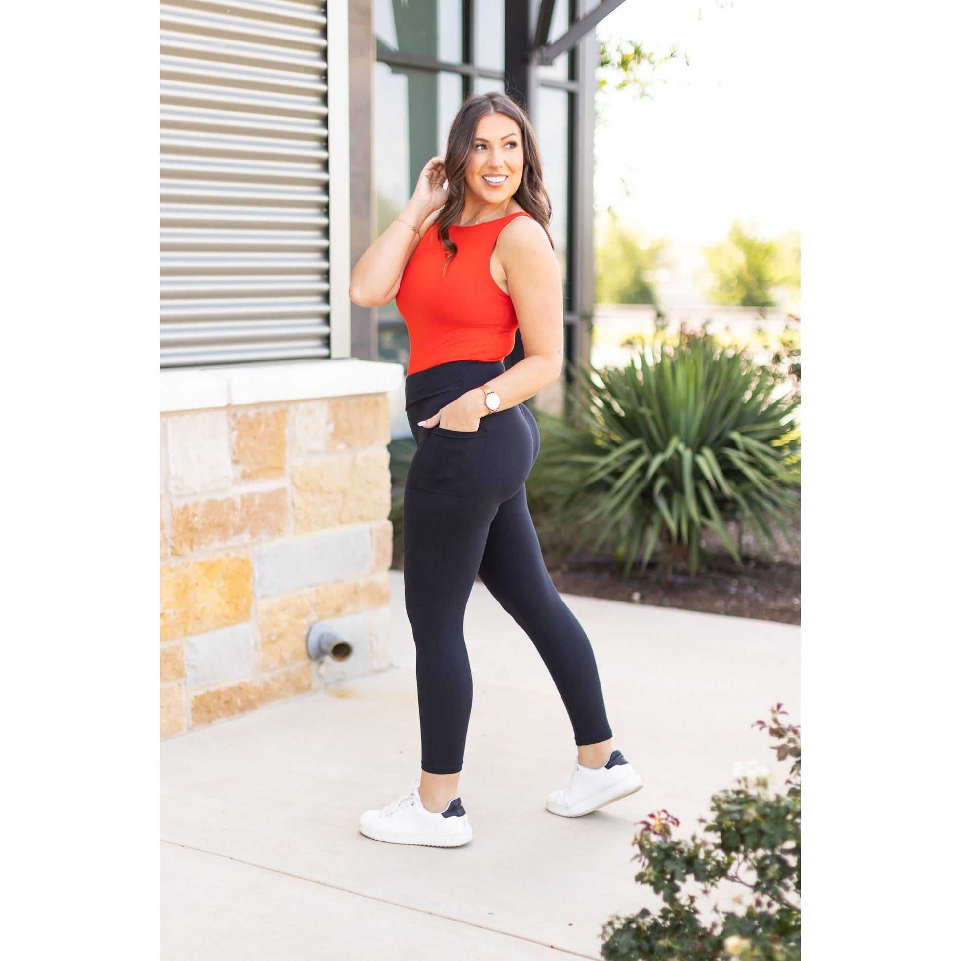 High-waisted black ankle length leggings with pockets by Julia Rose, Julia Rose women’s black 7/8 leggings lifestyle image