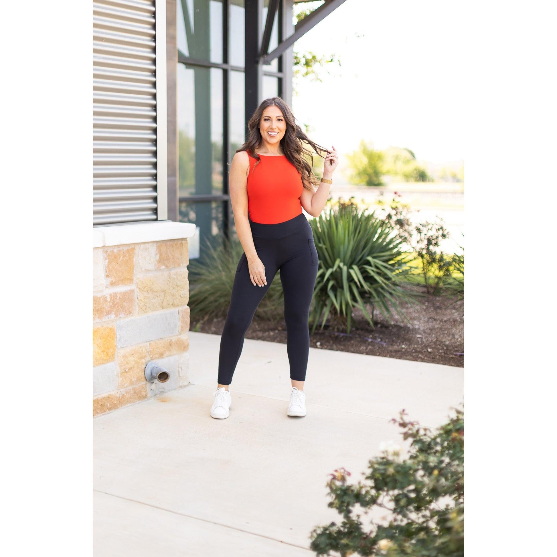 High-waisted black ankle length leggings with pockets by Julia Rose, Julia Rose women’s black 7/8 leggings lifestyle image