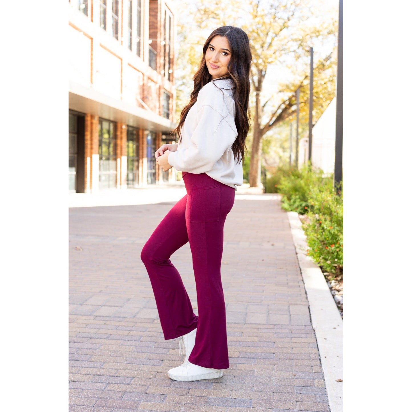 High-waisted maroon bootcut leggings with pockets by Julia Rose, Julia Rose women’s maroon flared leggings lifestyle image