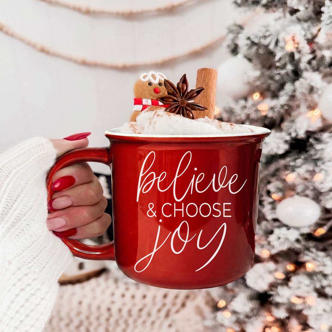 red ceramic mug that says believe and choose joy for Christmas
green Christmas coffee mug with inspirational holiday saying
cute festive mug for drinking coffee by the Christmas tree
cozy ceramic Christmas cup for hot chocolate and winter drinks
farmhouse style Christmas mug for kitchen decor