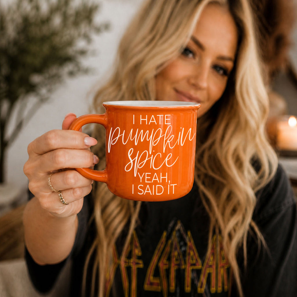 funny orange coffee cup on woven rattan tray
autumn evening scene with book blanket and mug
bright orange fall mug with soft natural light