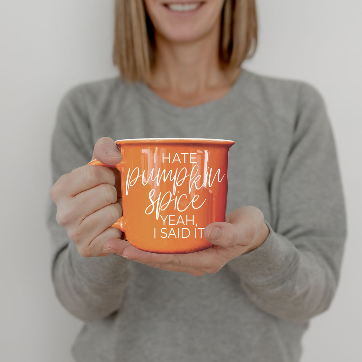 autumn breakfast table with coffee and orange mug
funny fall drinkware on neutral background
orange coffee cup in boho fall home decor
