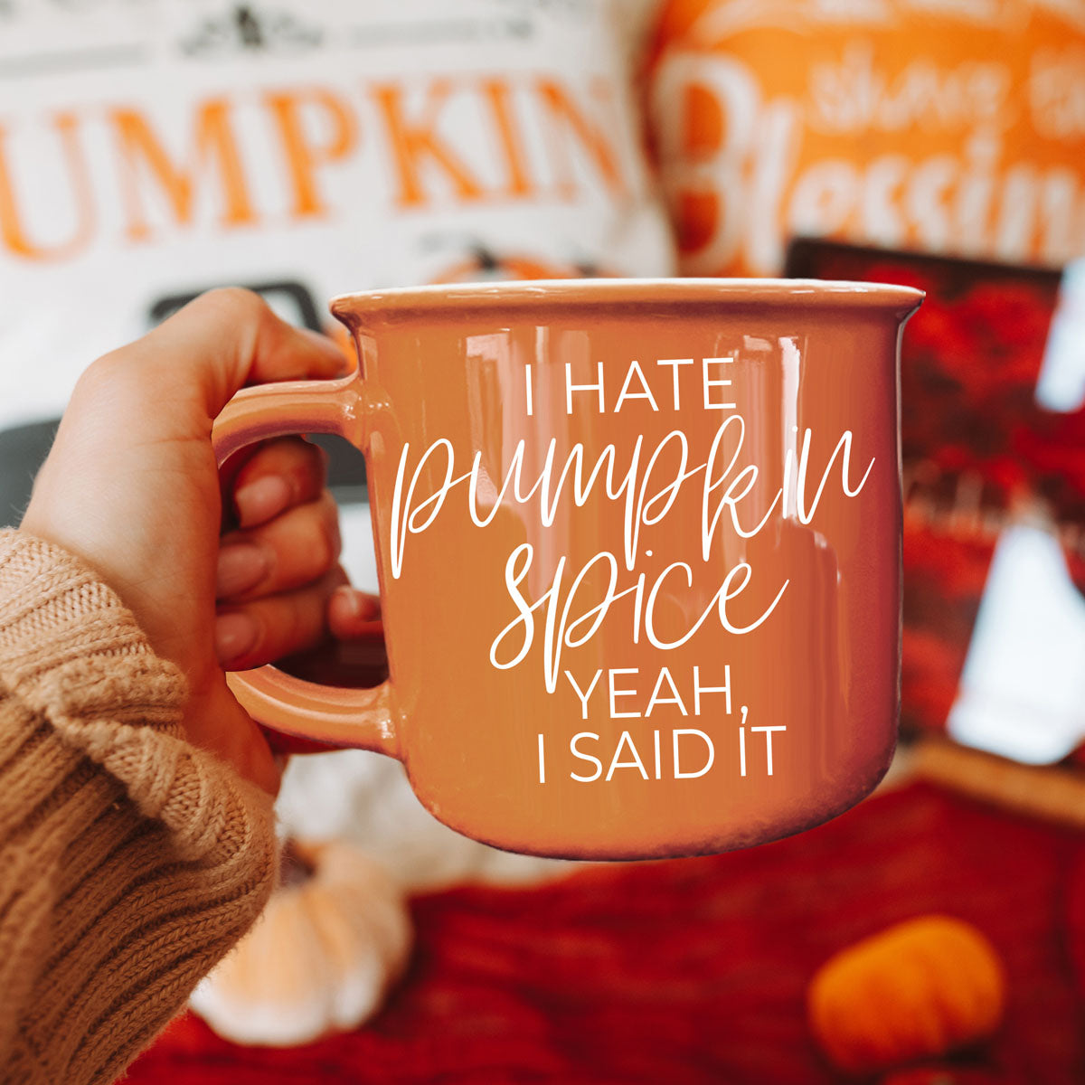 funny fall coffee mug gift for sarcastic sister
orange autumn mug wrapped in knit scarf
cozy campfire scene with bright orange coffee cup