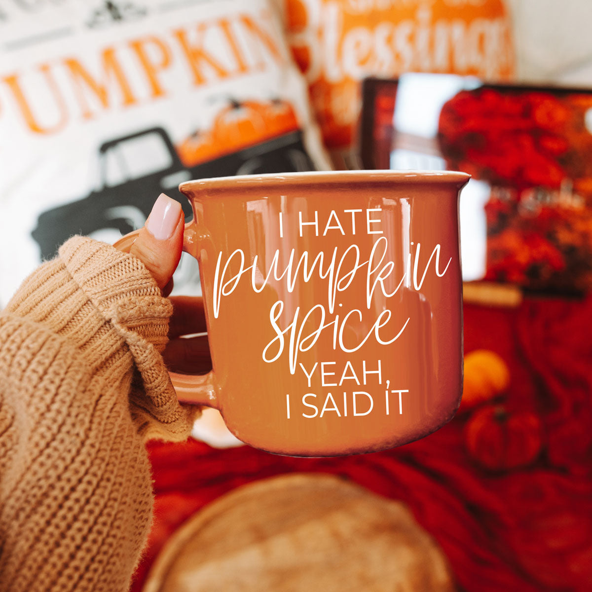 autumn evening scene with book blanket and mug
bright orange fall mug with soft natural light