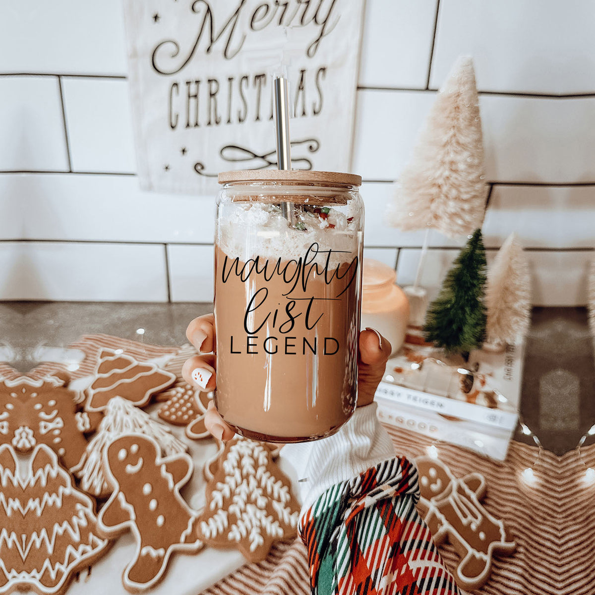 Shop this funny Naughty List Legend 17oz Christmas glass tumbler with bamboo lid and reusable metal straw. A festive holiday iced coffee cup and Christmas gift for women, coffee lovers, coworkers, friends, moms, and Secret Santa exchanges.